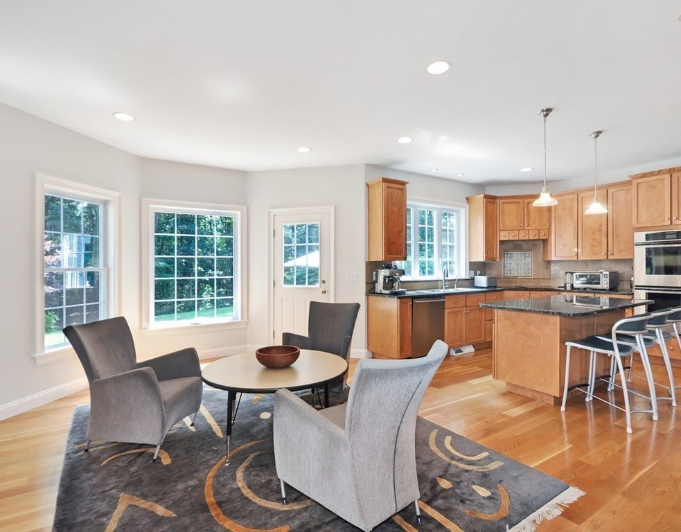 120 Colonial Ridge Drive Boxborough, MA 01719 - Photo 12 of 28 a dining room with furniture a rug and a kitchen view