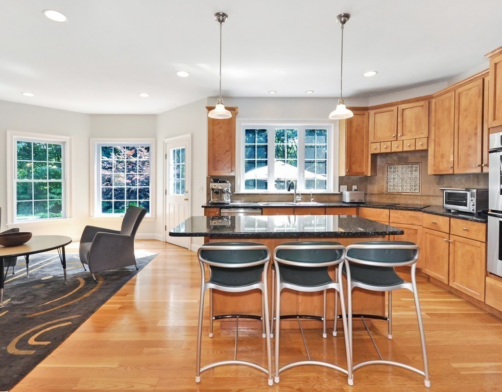 120 Colonial Ridge Drive Boxborough, MA 01719 - Photo 13 of 28 a kitchen with granite countertop wooden cabinets and chairs