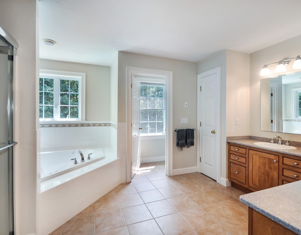 120 Colonial Ridge Drive Boxborough, MA 01719 - Photo 19 of 28 a bathroom with a tub sink and mirror