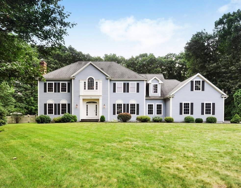 120 Colonial Ridge Drive Boxborough, MA 01719 - Photo 2 of 28 a front view of a house with a garden and trees