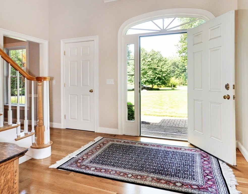 120 Colonial Ridge Drive Boxborough, MA 01719 - Photo 4 of 28 a view of a hallway with wooden floor and a rug