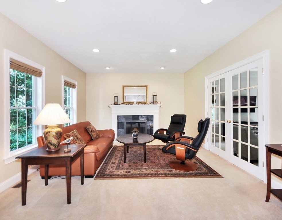 120 Colonial Ridge Drive Boxborough, MA 01719 - Photo 6 of 28 a living room with furniture a fireplace and a large window