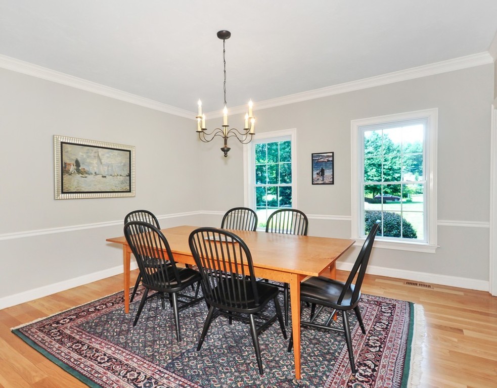 120 Colonial Ridge Drive Boxborough, MA 01719 - Photo 7 of 28 a view of a dining room and livingroom with furniture wooden floor a rug a rug and a chandelier