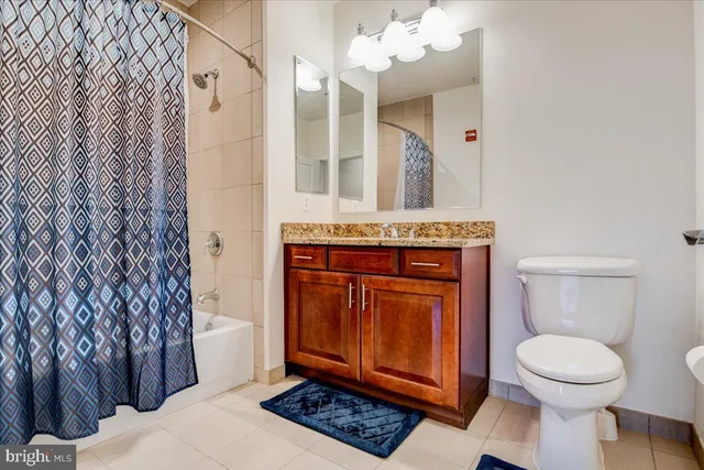 a spacious bathroom with a toilet a sink and a mirror
