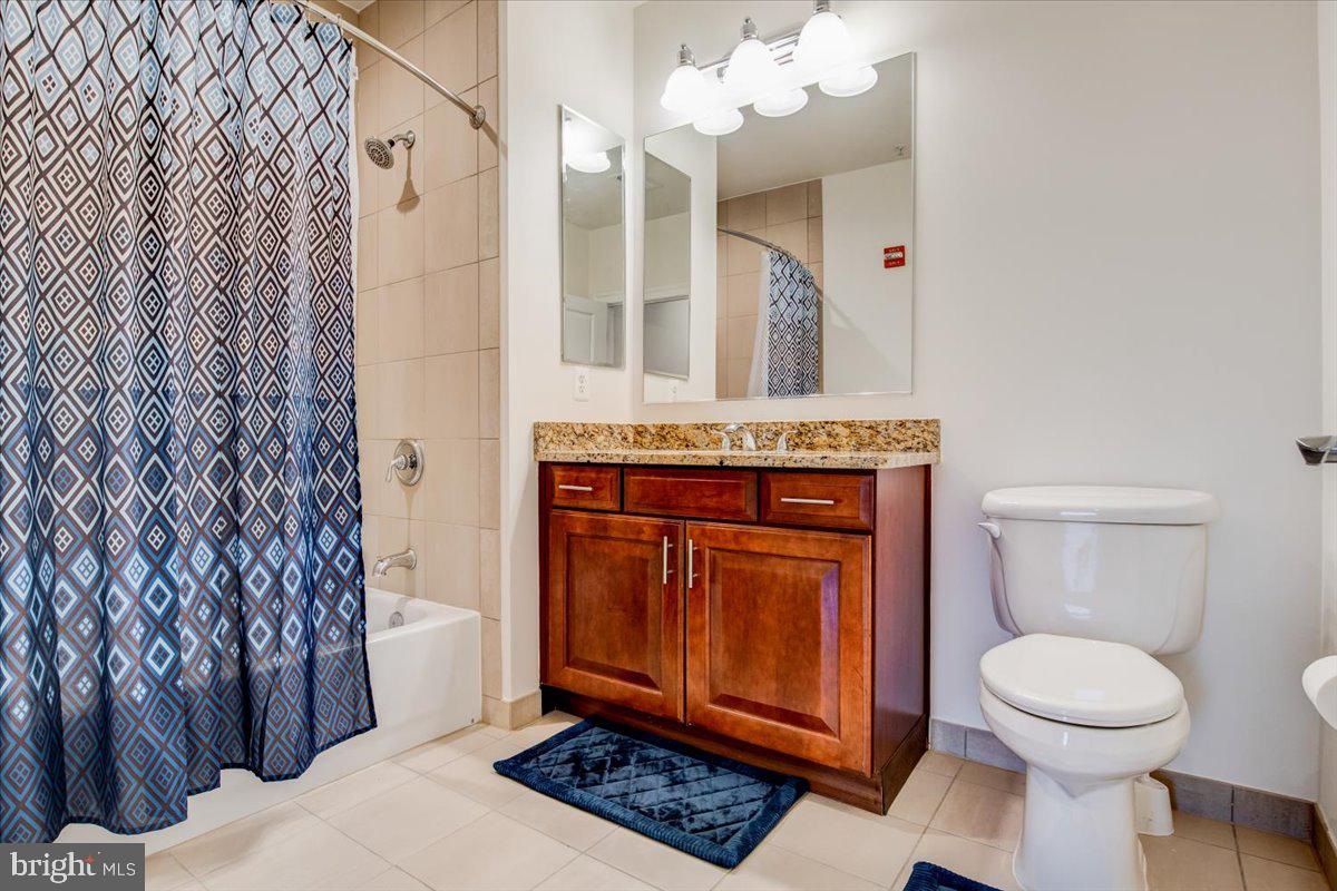 1023 North Royal Street, Unit 208 Alexandria, VA 22314 - Photo 11 of 29 a spacious bathroom with a toilet a sink and a mirror