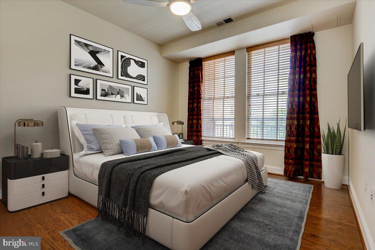 1023 North Royal Street, Unit 208 Alexandria, VA 22314 - Photo 12 of 29 a bed room with a bed and a large window