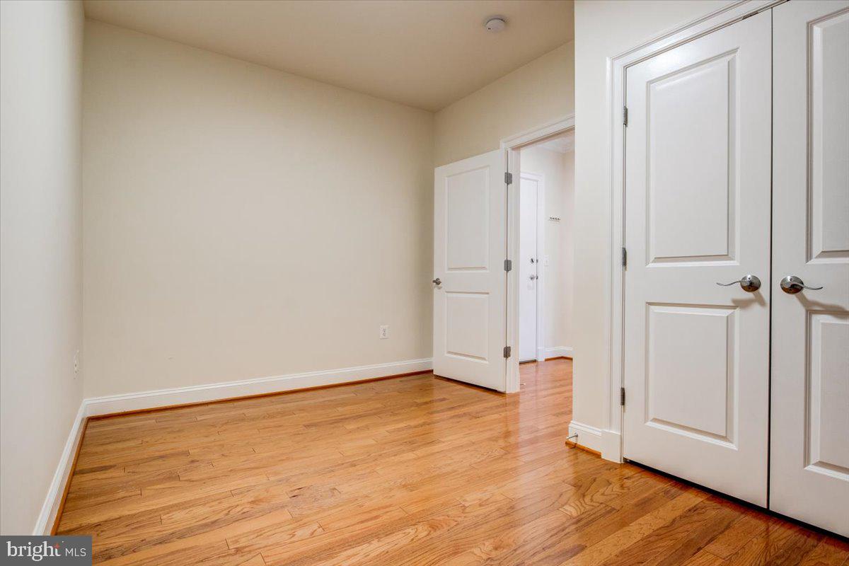 1023 North Royal Street, Unit 208 Alexandria, VA 22314 - Photo 18 of 29 wooden floor in an empty room