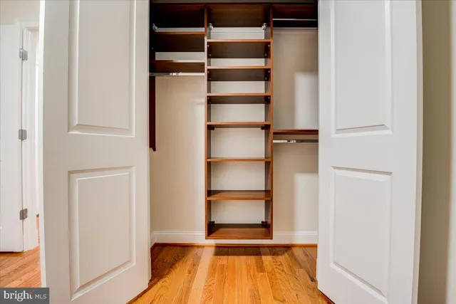 a view of walk in closet with empty racks