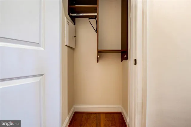 a view of walk in closet with clothes