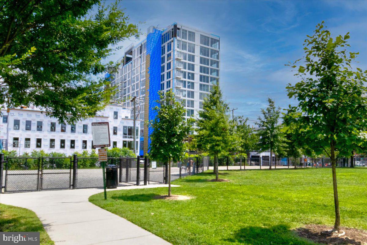 1023 North Royal Street, Unit 208 Alexandria, VA 22314 - Photo 28 of 29 a front view of a building with a garden
