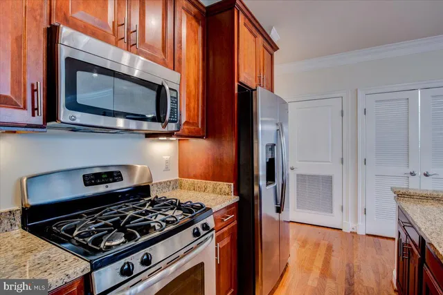 a kitchen with stainless steel appliances granite countertop a stove and a microwave
