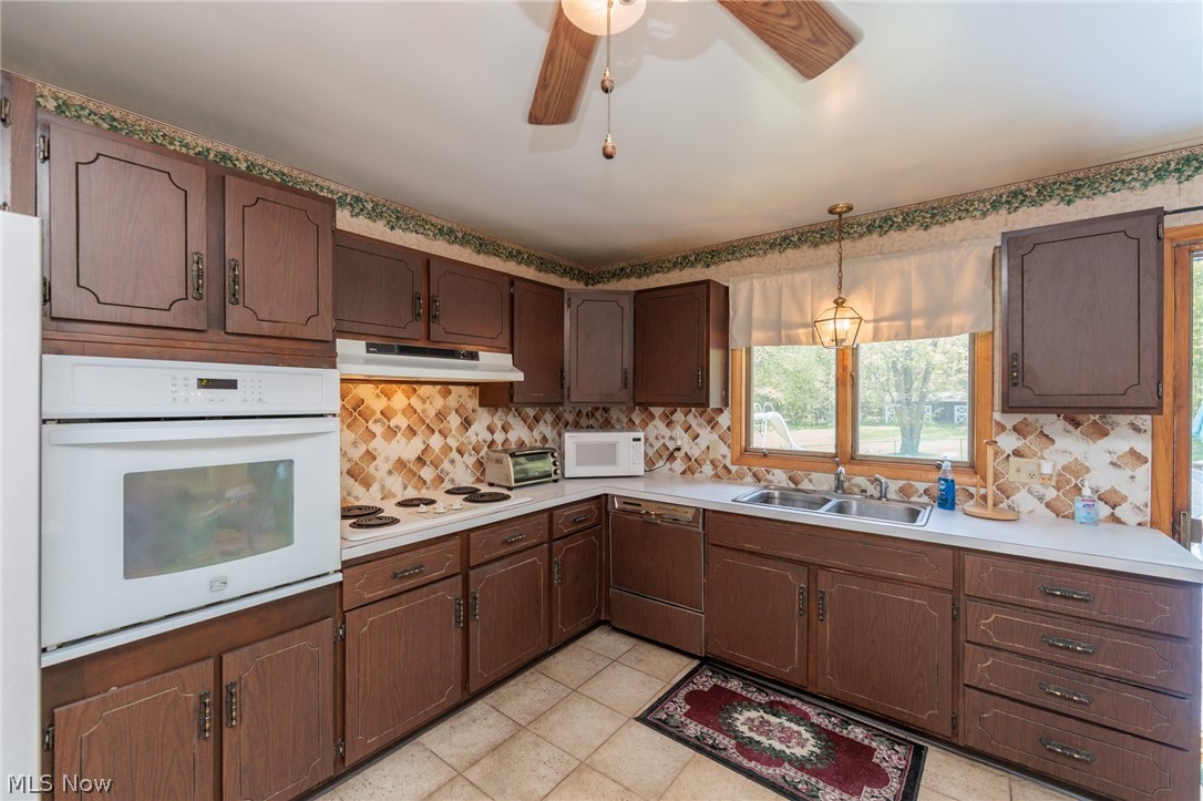2170 Norton Road Stow, OH 44224 - Photo 33 of 48 Kitchen featuring wood-finish cabinetry, built-in wall oven, and white countertop space