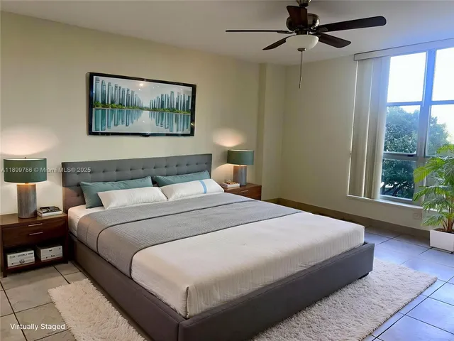 a bedroom with a large bed and a painting on the wall