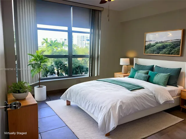 a bedroom with a bed and a large window