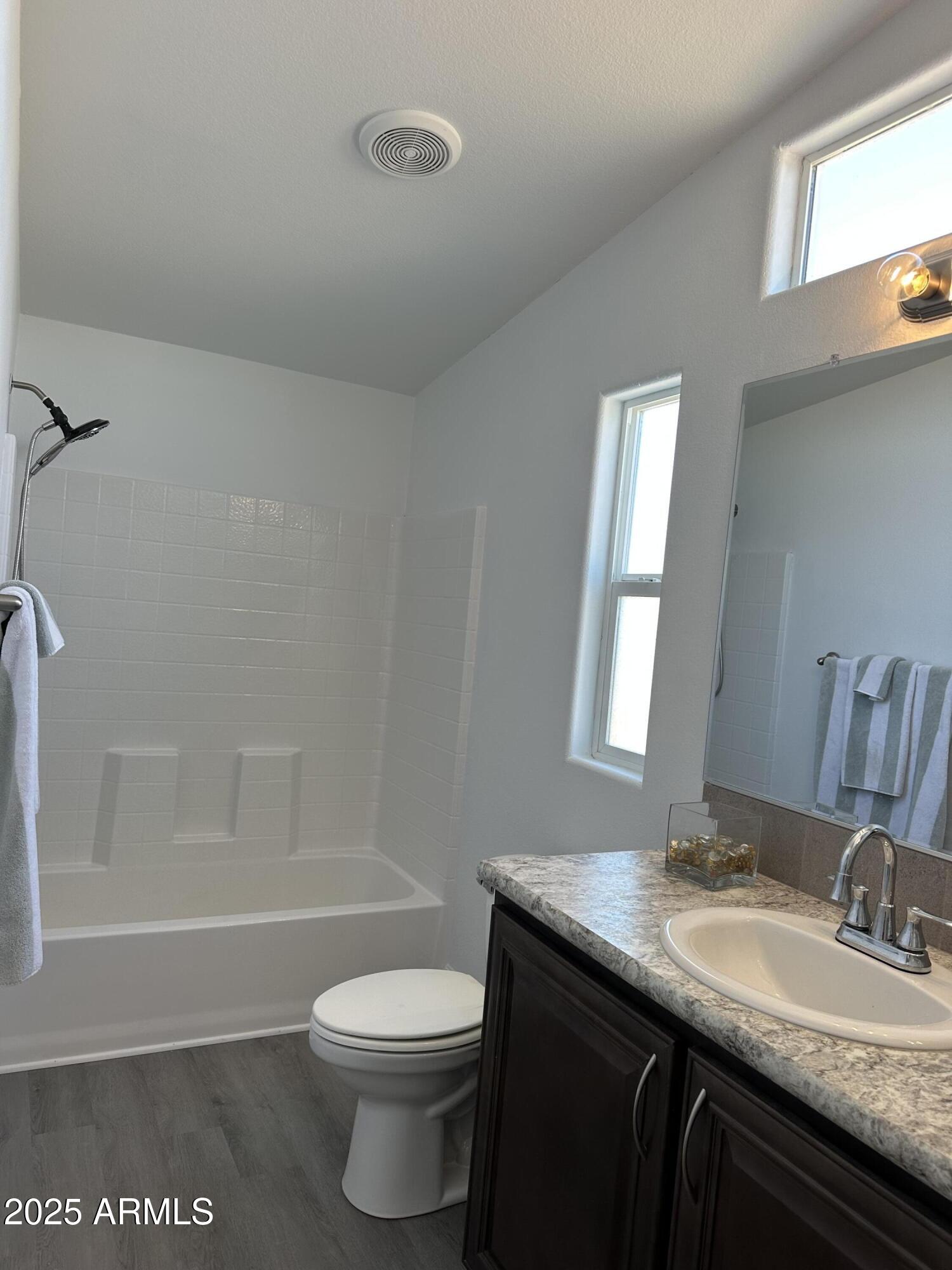 38007 West McDowell Road Tonopah, AZ 85354 - Photo 15 of 44 a bathroom with a granite countertop sink toilet and shower