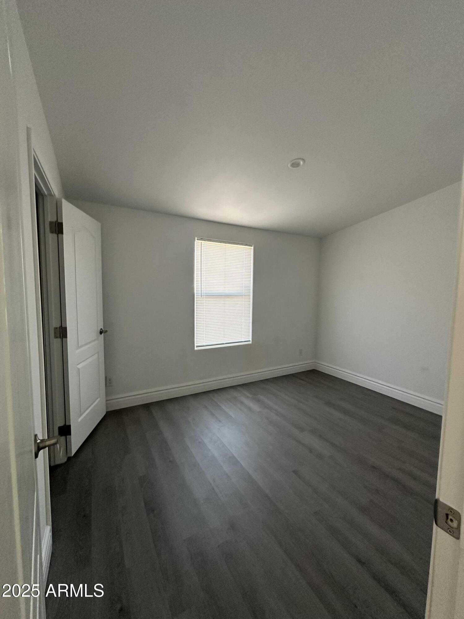 38007 West McDowell Road Tonopah, AZ 85354 - Photo 18 of 44 an empty room with wooden floor and windows