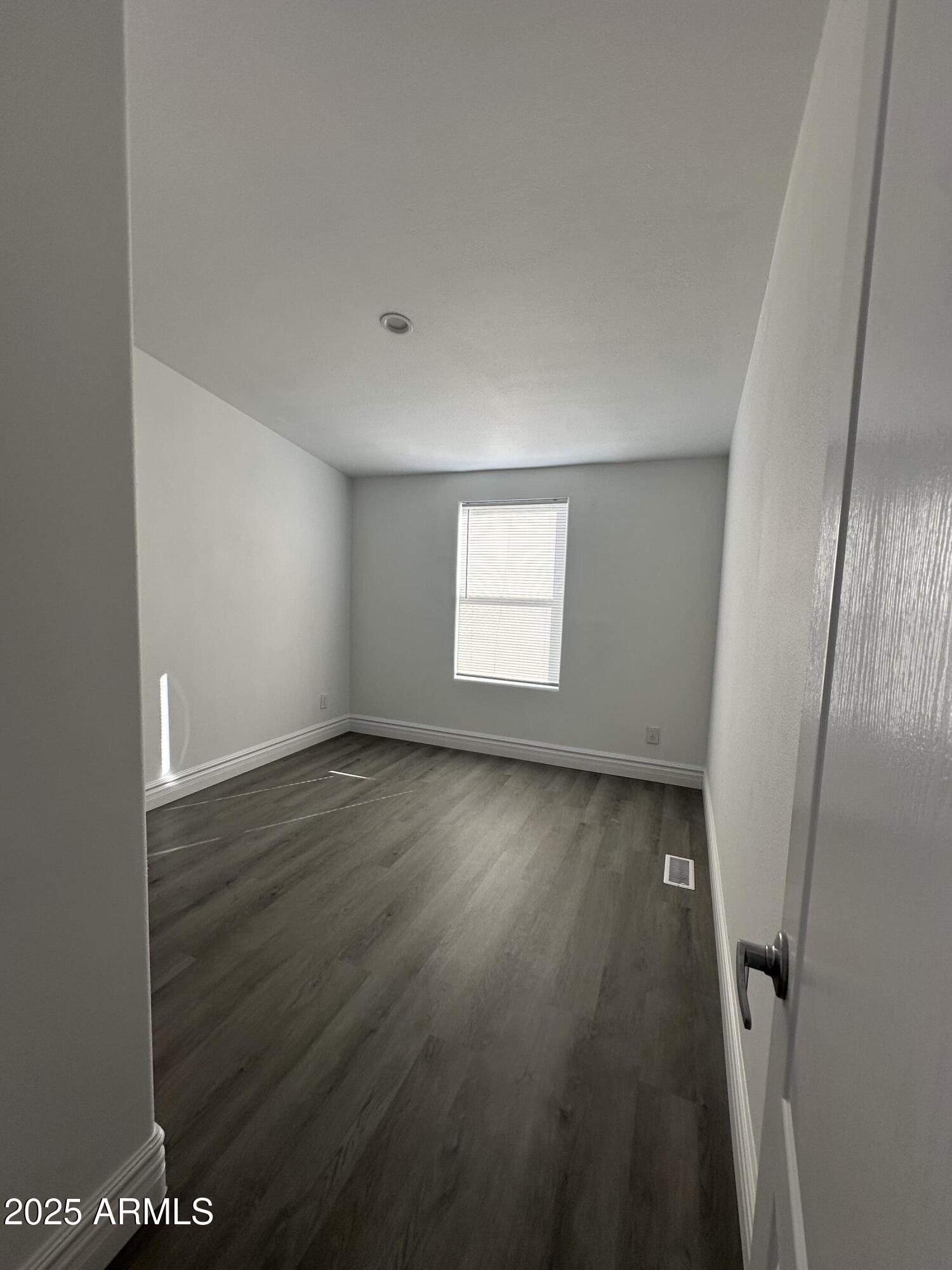 38007 West McDowell Road Tonopah, AZ 85354 - Photo 19 of 44 an empty room with wooden floor and windows