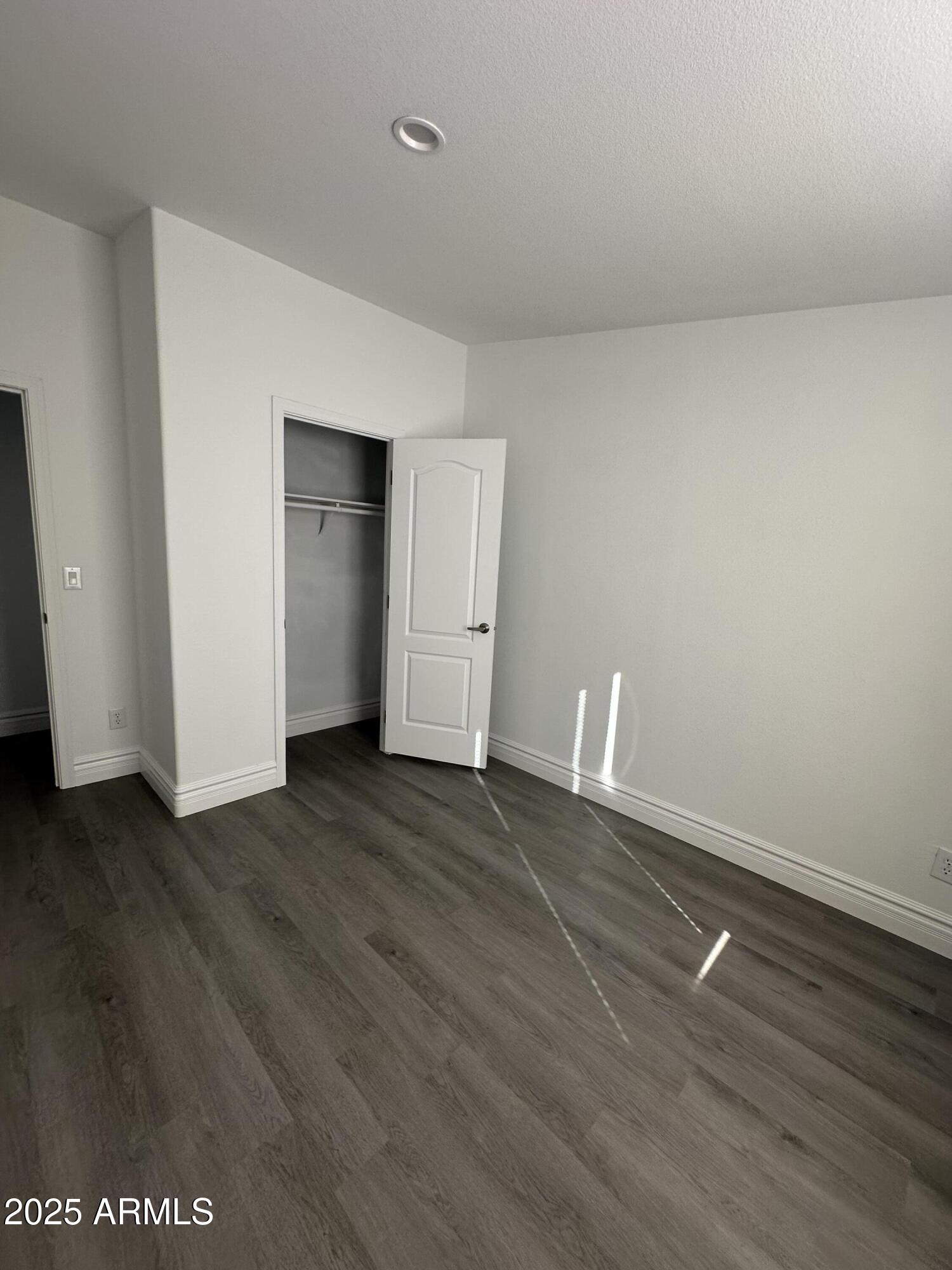 38007 West McDowell Road Tonopah, AZ 85354 - Photo 20 of 44 a view of an empty room with wooden floor and window