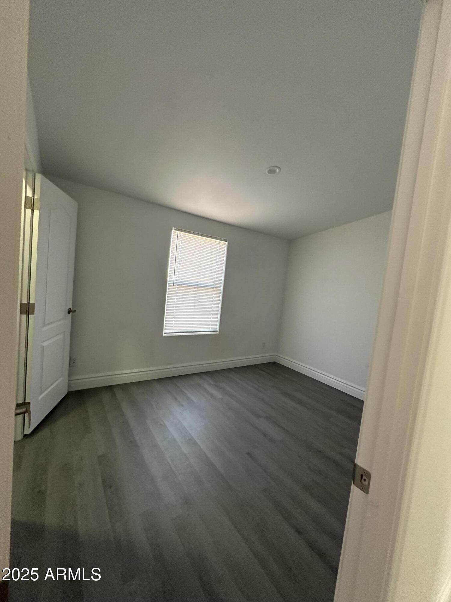 38007 West McDowell Road Tonopah, AZ 85354 - Photo 21 of 44 an empty room with wooden floor and window