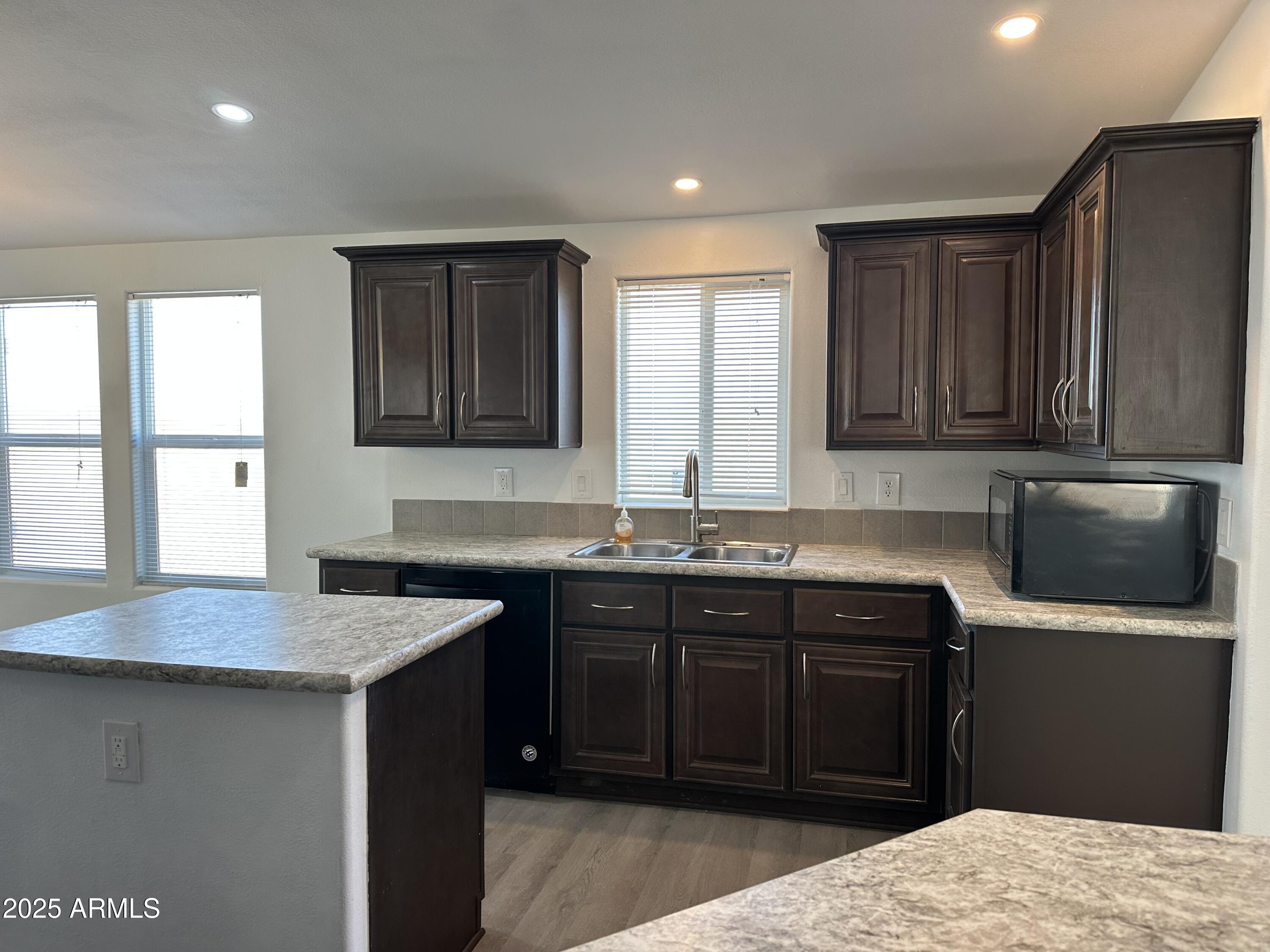 38007 West McDowell Road Tonopah, AZ 85354 - Photo 25 of 44 a kitchen with a sink stove and cabinets