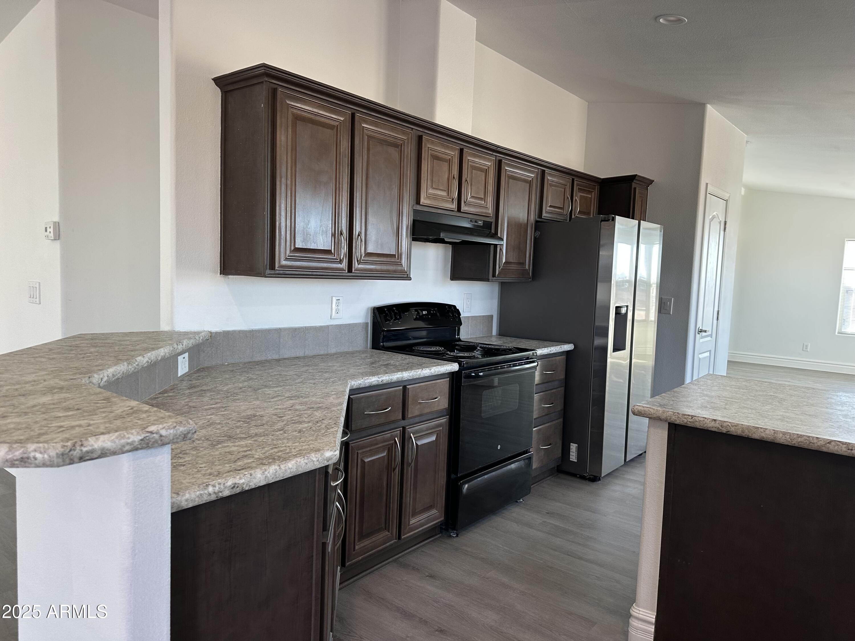 38007 West McDowell Road Tonopah, AZ 85354 - Photo 28 of 44 a kitchen with stainless steel appliances granite countertop a sink stove and refrigerator