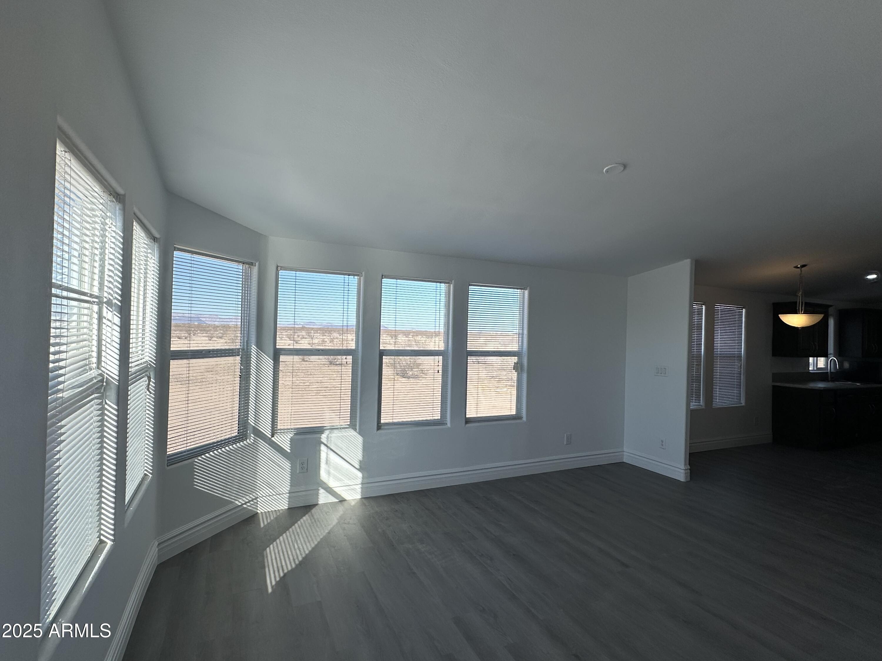 38007 West McDowell Road Tonopah, AZ 85354 - Photo 35 of 44 a view of an empty room with wooden floor and a window