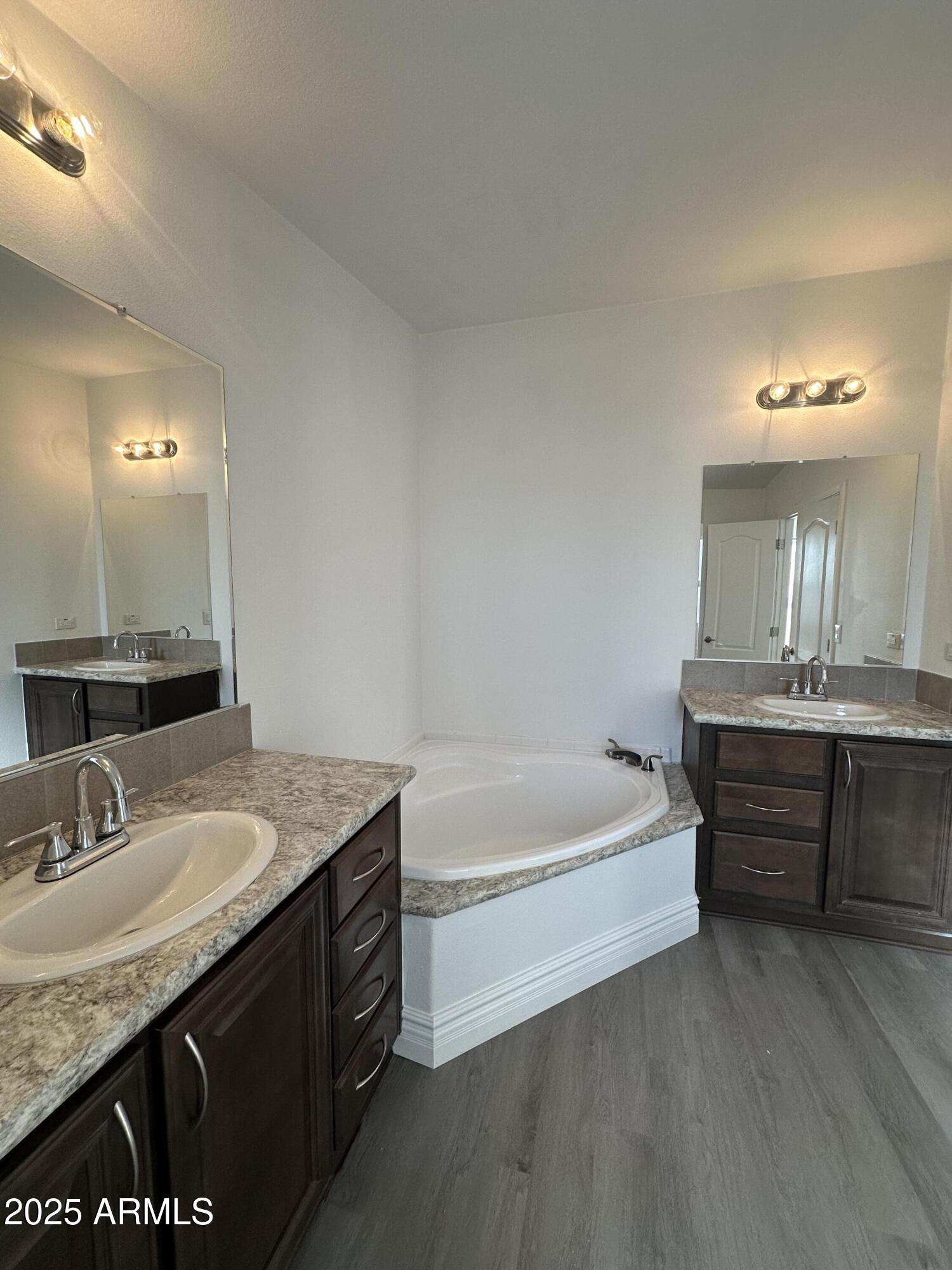 38007 West McDowell Road Tonopah, AZ 85354 - Photo 36 of 44 a bathroom with a granite countertop bathtub sink vanity and mirror