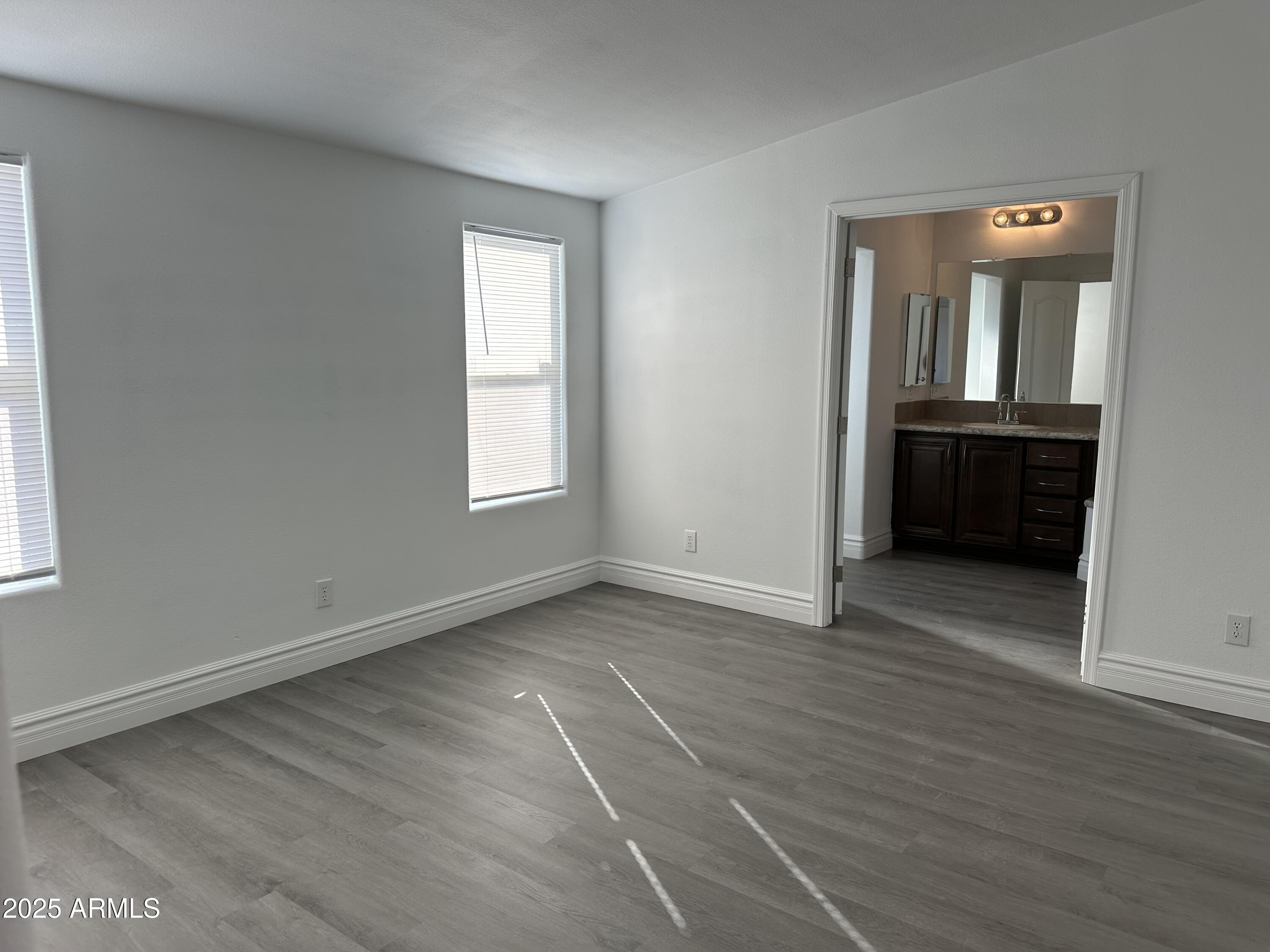 38007 West McDowell Road Tonopah, AZ 85354 - Photo 10 of 44 an empty room with wooden floor and windows