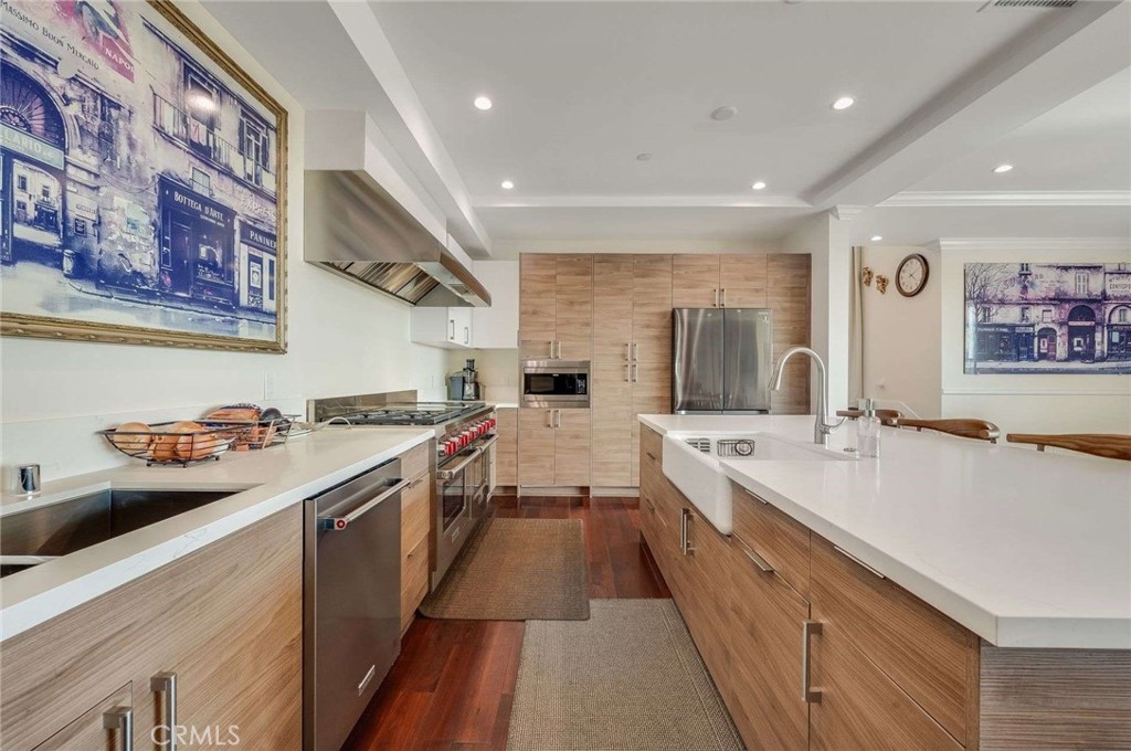 11837 Rideout Way Whittier, CA 90601 - Photo 11 of 44 a large kitchen with stainless steel appliances lots of counter space and wooden floor