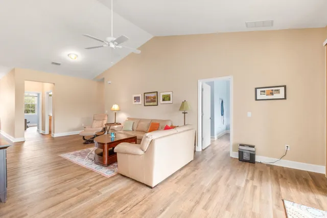 a living room with furniture and a wooden floor
