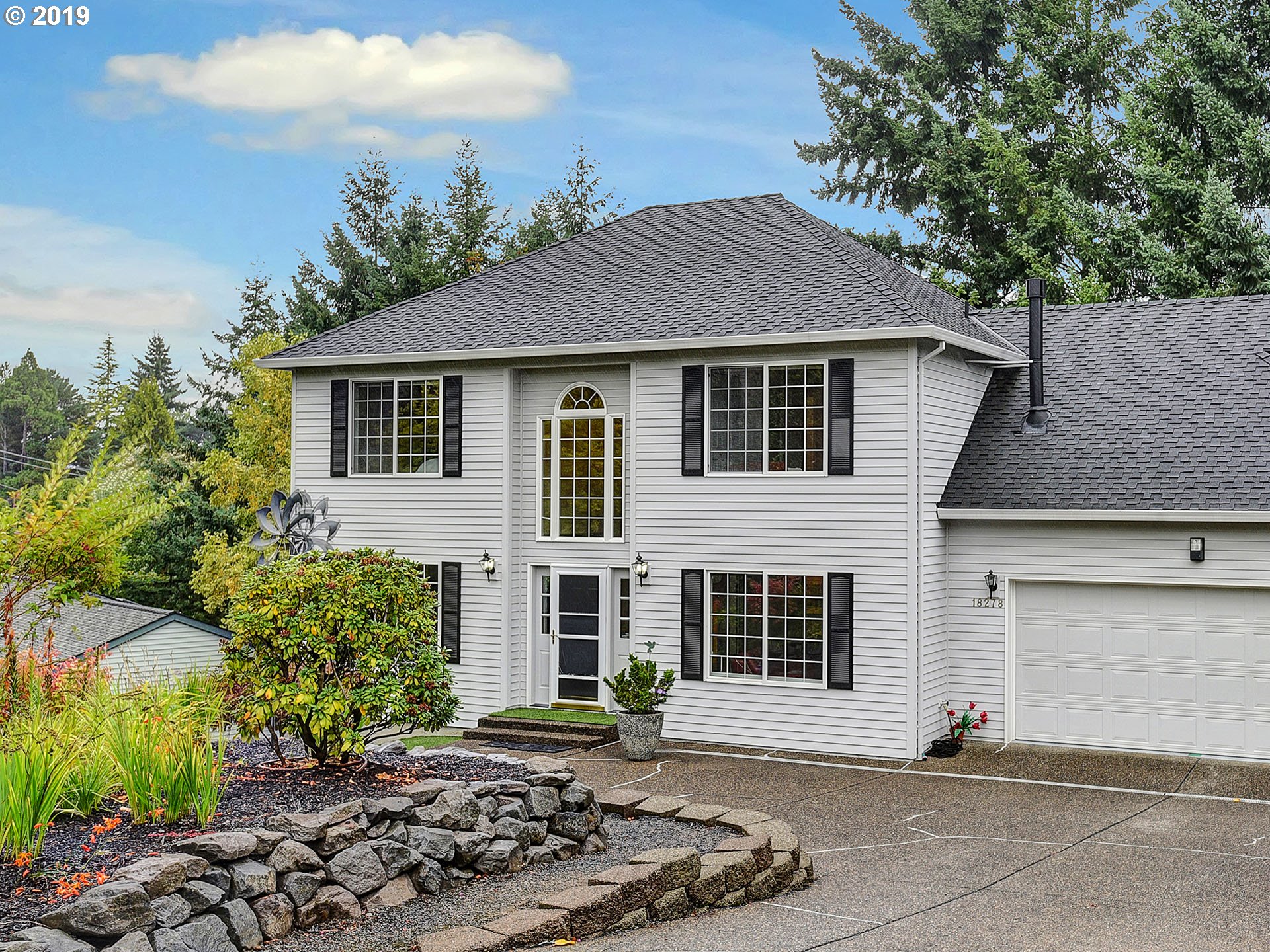 18278 Southwest Fallatin Loop Beaverton, OR 97007 - Photo 1 of 32 a front view of a house with a yard