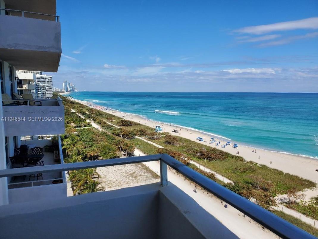 a view of a floor to ceiling window and an ocean