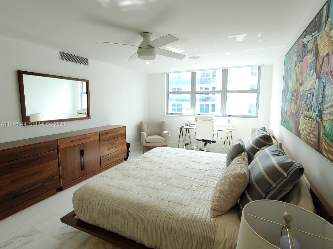 9225 Collins Avenue, Unit 1102 Surfside, FL 33154 - Photo 11 of 15 a bedroom with a bed and window