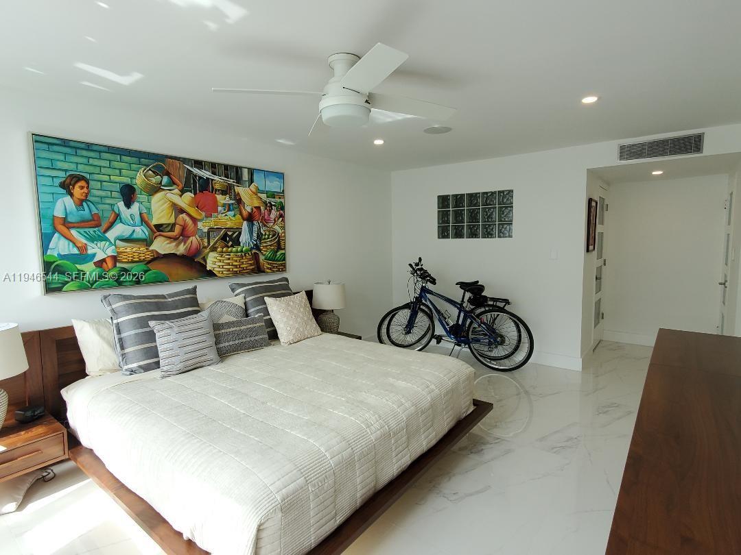 9225 Collins Avenue, Unit 1102 Surfside, FL 33154 - Photo 12 of 15 a bedroom with furniture and a large window