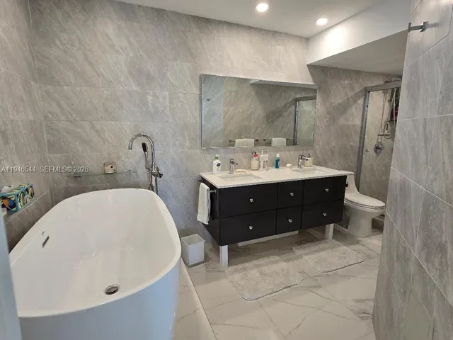 a en suite bathroom with a sink and a mirror
