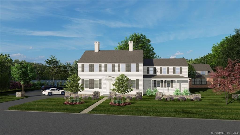 a front view of a house with a garden and yard