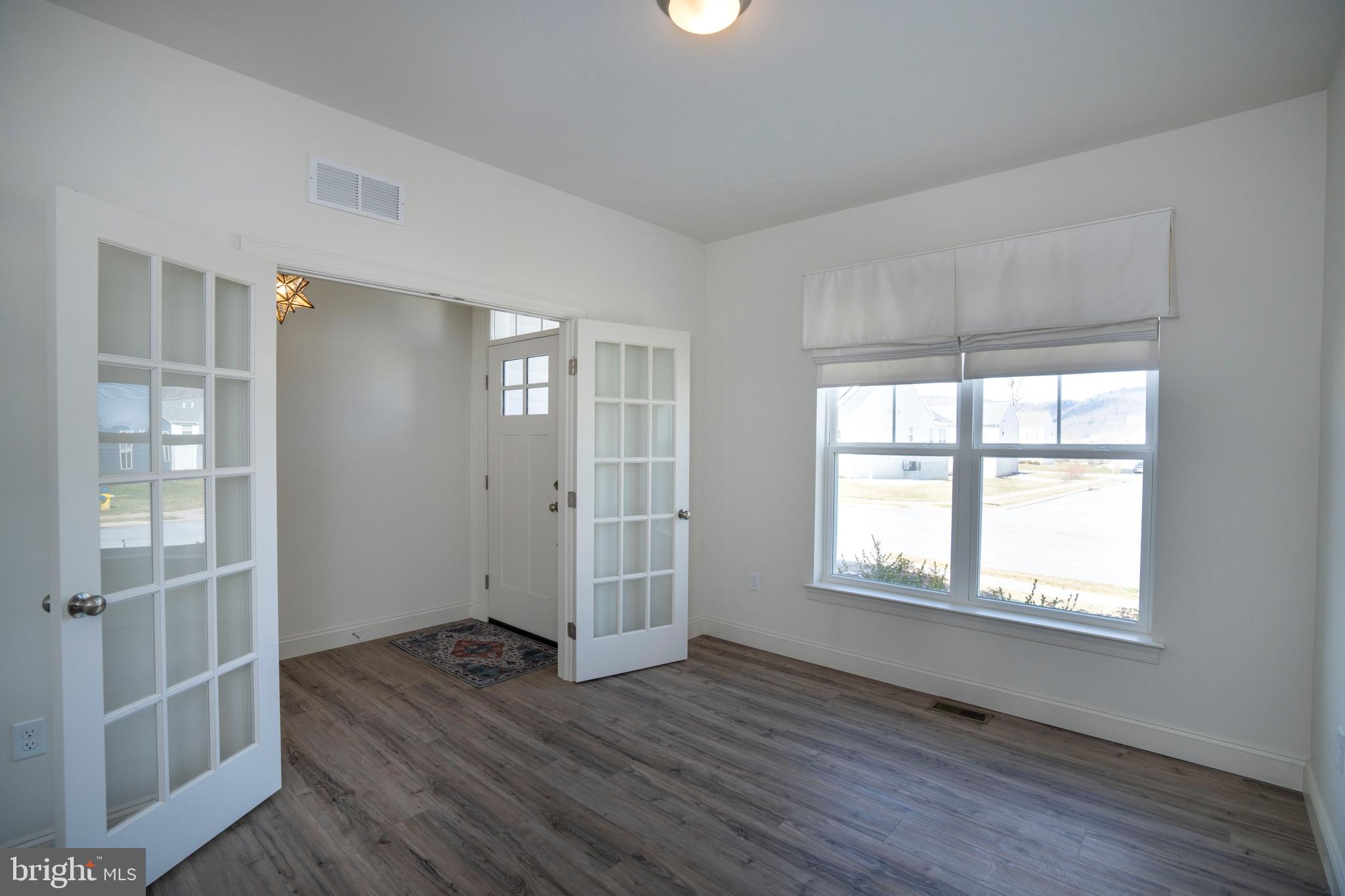 453 Fawn Valley Road State College, PA 16803 - Photo 5 of 51 an empty room with wooden floor and windows