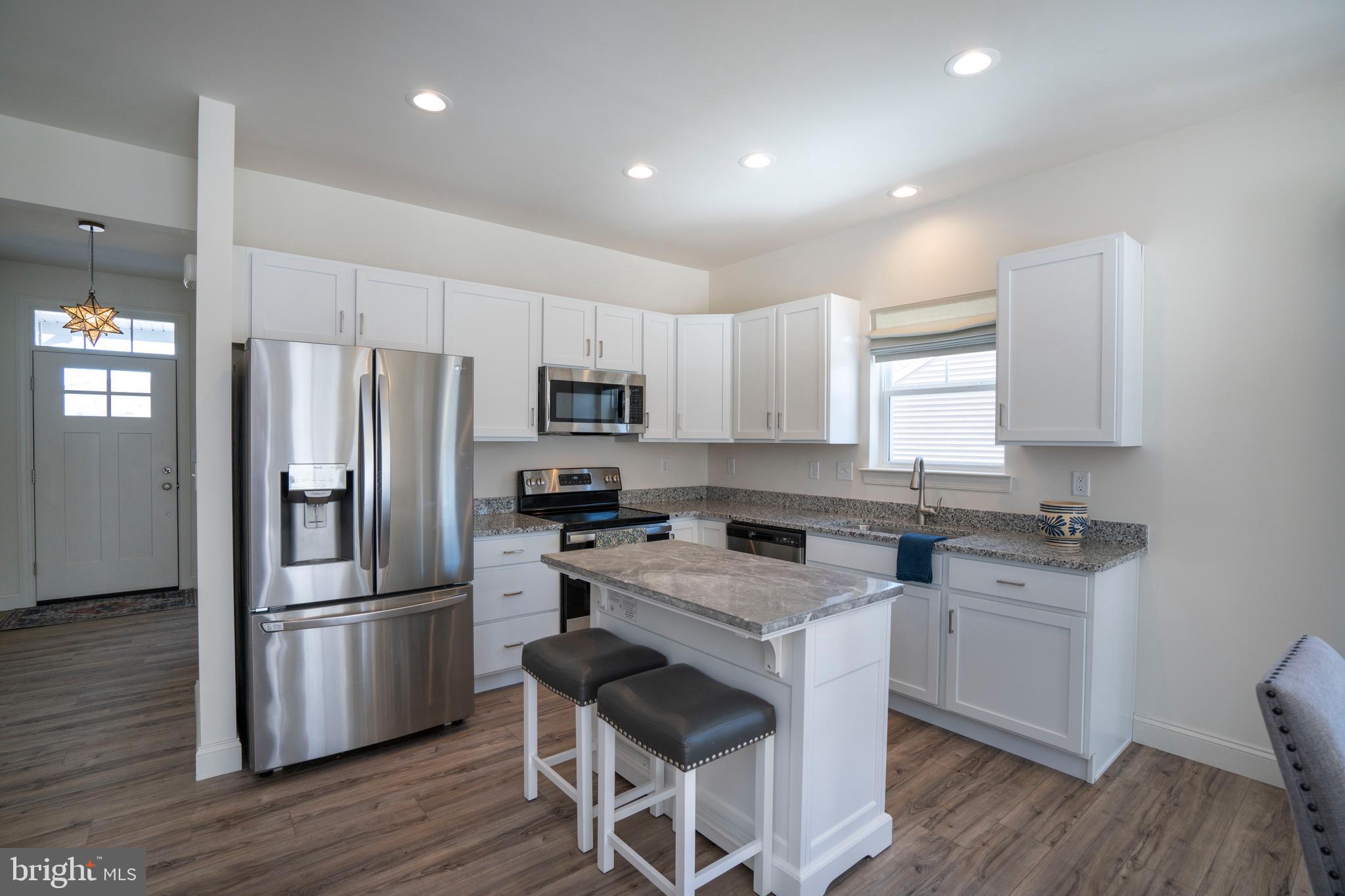 453 Fawn Valley Road State College, PA 16803 - Photo 7 of 51 a kitchen with a center island stainless steel appliances cabinets and wooden floor
