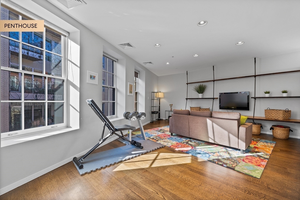 133 Salem Street Boston, MA 02113 - Photo 10 of 27 a living room with furniture gym equipment and a flat screen tv