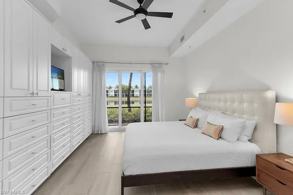 a bedroom with a bed a window and closet