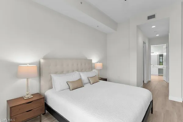 a bedroom with a bed and a lamp