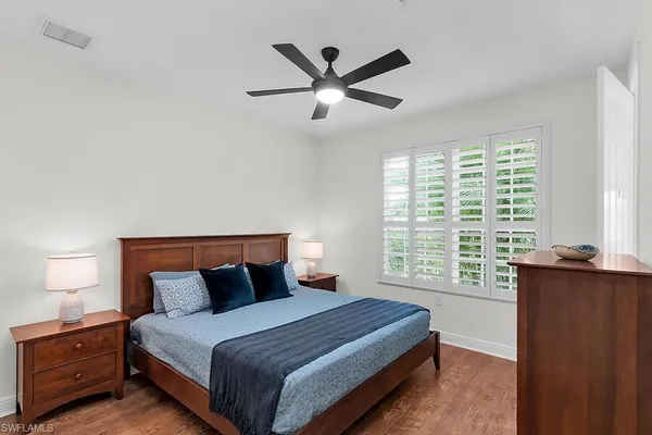 a bedroom with a large bed and a large window