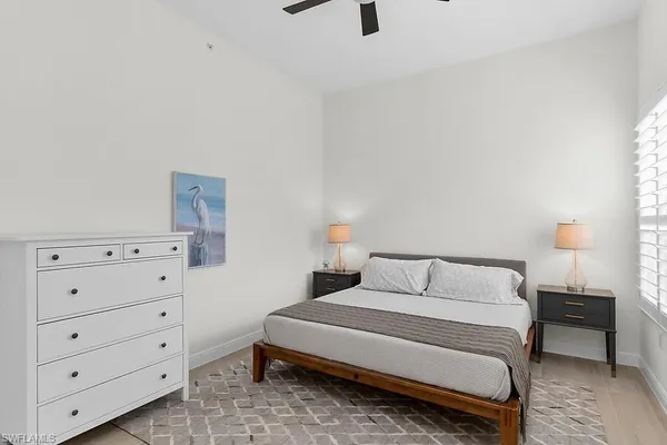 a bedroom with a bed and a night stand