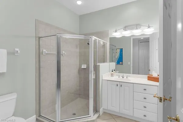 a bathroom with a double vanity sink mirror and shower
