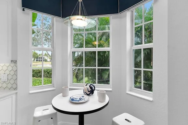 a dining room with a window and ceiling fan