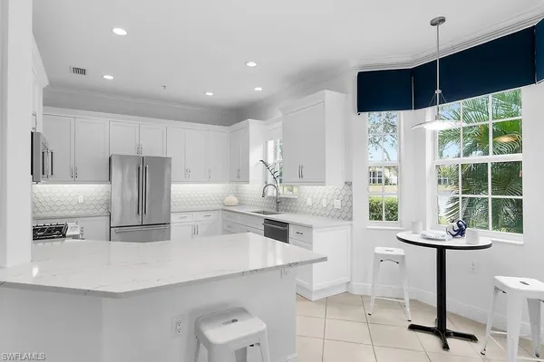a kitchen with stainless steel appliances a sink and a refrigerator