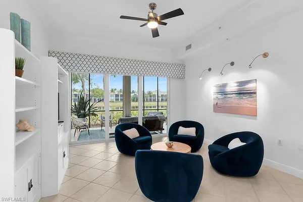 a living room with furniture and a large window