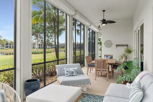 a living room with furniture and a floor to ceiling window
