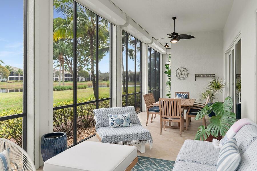 9292 Belle Court, Unit 101 Naples, FL 34114 - Photo 27 of 43 Lanai featuring water view all around, outdoor dining area, ceiling fan, outdoor living space