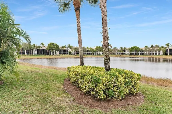 a view of a lake with houses in the back
